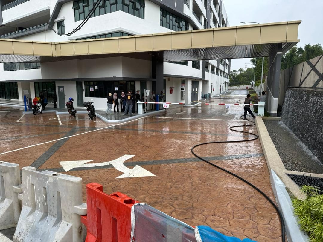 A wet stamped-concrete drop-off being washed down before handover
