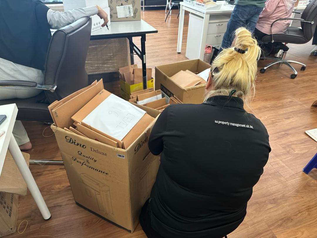 Unit envelopes and files being packed into boxes for a vacant possession handover