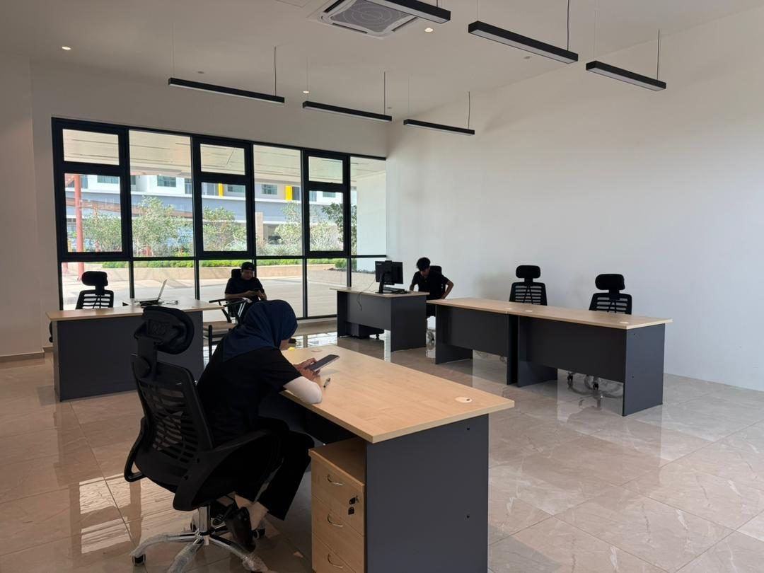Staff working at desks in a completed management office