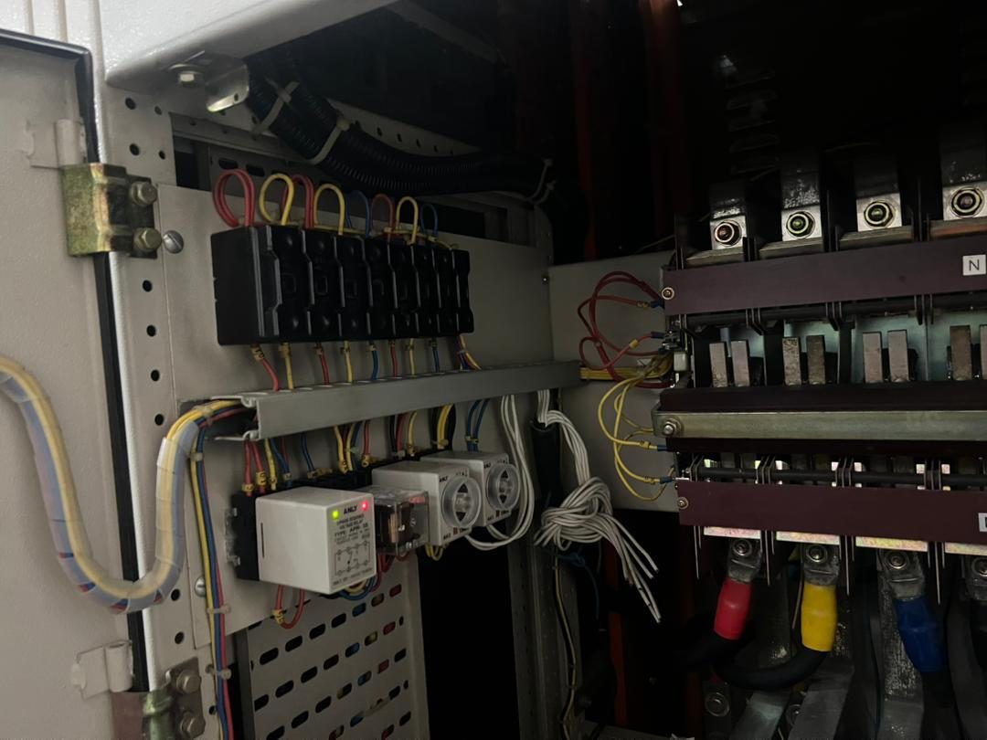 An open electrical distribution board showing fuses, terminations and cabling