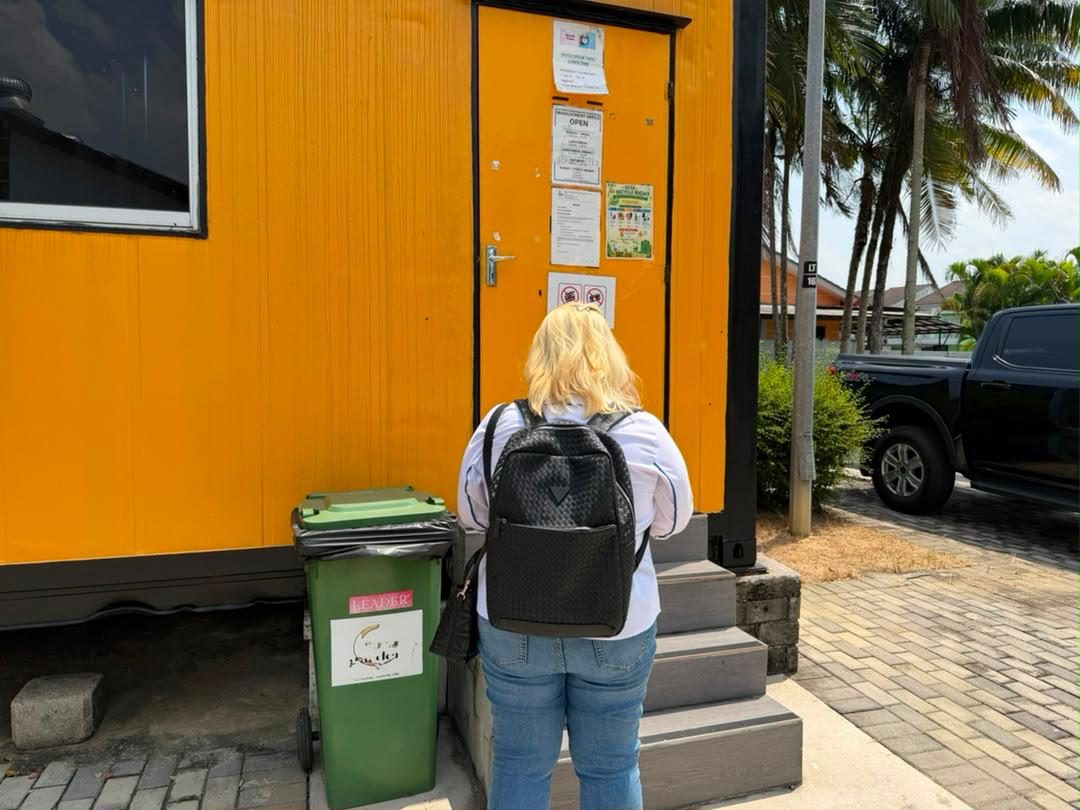 Nelfar Zulkifli at the door of an orange site office container