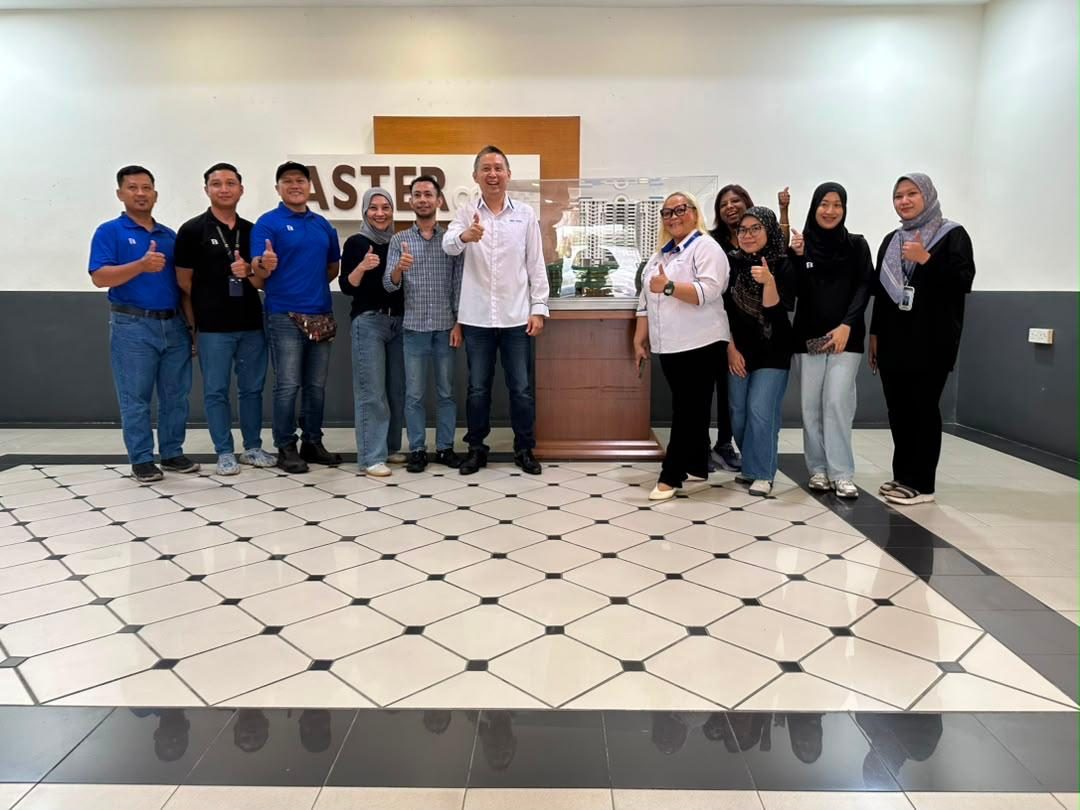 Nelfar Zulkifli and colleagues beside a scale model of a development