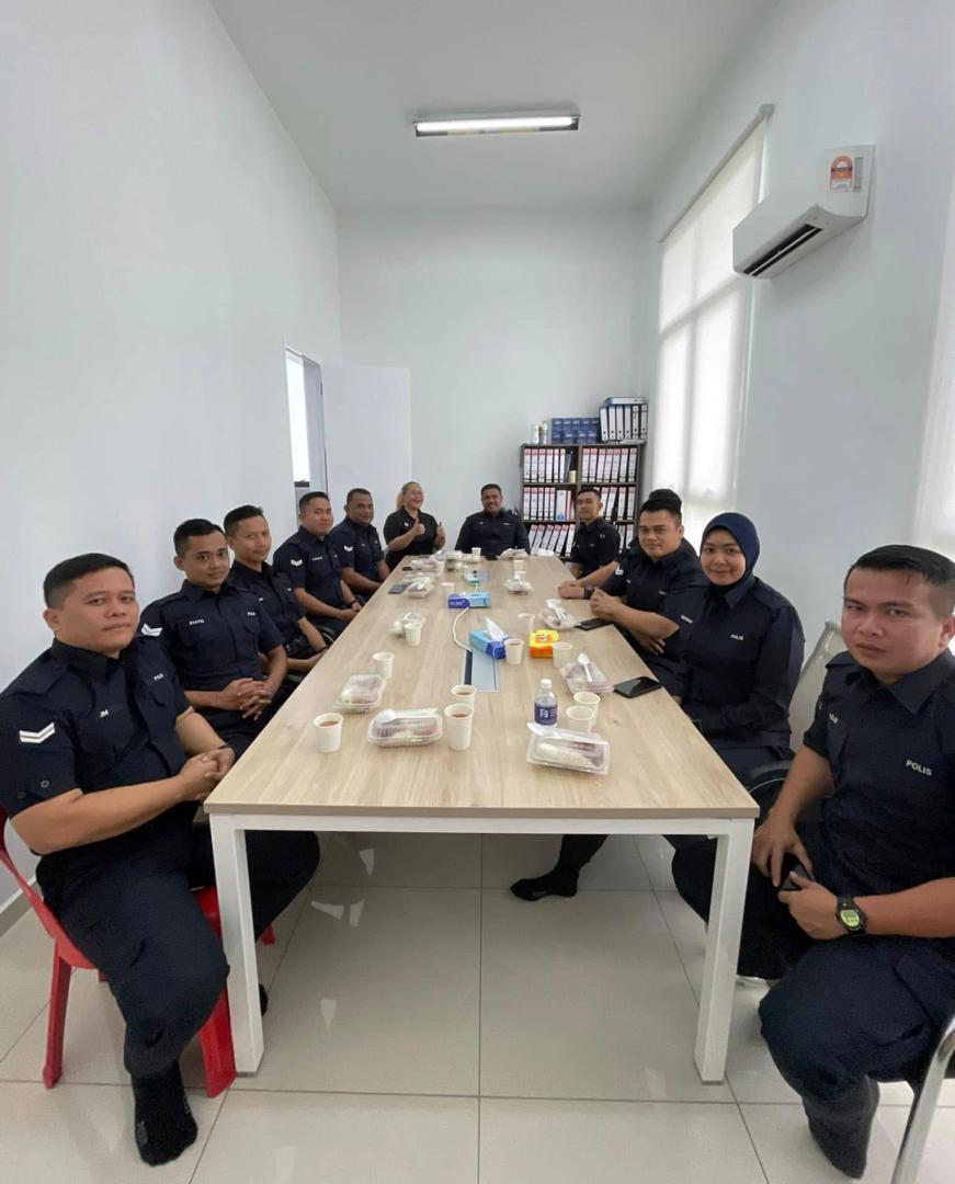 Officers from Balai Polis Setia Indah seated around a table before the session