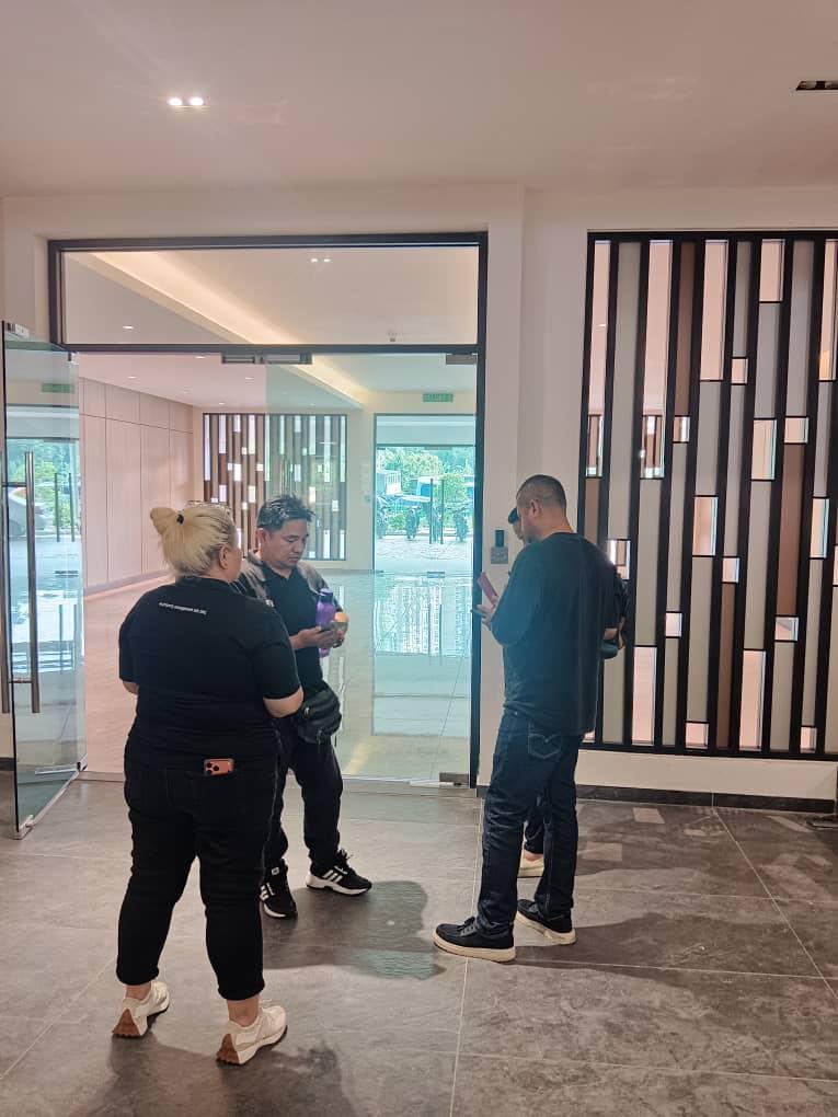Nelfar Zulkifli with vendors in the lobby of a newly completed development during a site visit